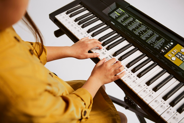 girl playing electric keyboard